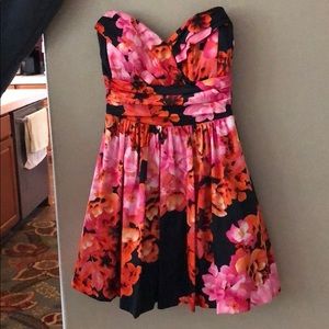 A black, pink and orange strapless dress